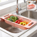 Pink plastic adjustable over-sink drain basket with broccoli