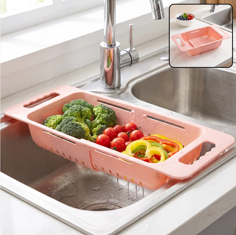 Pink plastic adjustable over-sink drain basket with broccoli